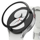 Galaxy Watch 5/4 40mm | Bezel Styling - A black adhesive bezel ring hovering above a silver Galaxy Watch with a white strap.