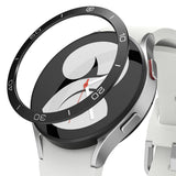 Galaxy Watch 5/4 40mm | Bezel Styling - Black adhesive bezel ring hovering above a silver smartwatch with a white band.