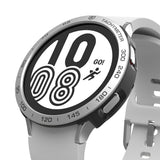 Galaxy Watch 4 44mm | Air Sports Black + Bezel Styling - Galaxy Watch 4 44mm - Silver Galaxy Watch 4 with a tachymeter bezel styling and a white sports band showing a digital clock.