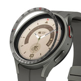 Galaxy Watch 5 Pro 45mm | Inner Bezel Styling - Galaxy Watch 5 Pro 45mm - A metallic bezel ring with tachymeter markings hovering above a grey smartwatch face.