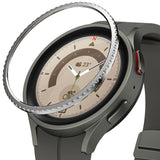 Galaxy Watch 5 Pro 45mm | Bezel Styling - A metallic, textured bezel ring hovering above a grey smartwatch face.