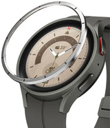 Galaxy Watch 5 Pro 45mm | Bezel Styling - A metallic bezel ring hovering above a grey Galaxy Watch 5 Pro smartwatch.