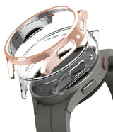 Galaxy Watch 5 Pro Case | Slim - Rose gold and clear protective watch cases hovering above a grey Galaxy Watch 5 Pro.