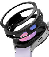 Galaxy Watch 5 40mm | Air Sports Black + Bezel Styling - Galaxy Watch 5 40mm | Air Sports Black bezel styling accessory hovering above a silver smartwatch with a light purple band.
