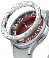 Galaxy Watch 6 Classic 43mm | Premium Bezel Styling - Galaxy Watch 6 Classic 43mm - Silver tachymeter bezel ring hovering above a smartwatch with a red dial and white strap.