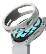 Galaxy Watch 6 40mm Case | Air Sports - A silver protective watch case hovering above a Galaxy Watch 6 with a blue face.
