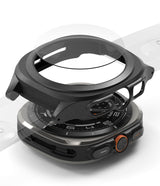Galaxy Watch Ultra | Slim Extend & Glass - Clear protective case hovering over a Galaxy Watch Ultra on a gray surface.