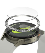 Galaxy Watch 7 (40mm) | Bezel Styling & Glass - Exploded view of a smartwatch with a metallic bezel and glass screen protector.