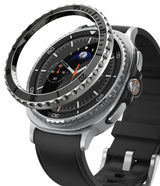 Galaxy Watch 8 Classic 46mm | Bezel Styling Premium - A black metal bezel ring hovering above a silver smartwatch.