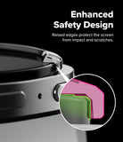 Galaxy Watch 9 / 8 40mm | Bezel Styling - Close-up of a smartwatch or similar cylindrical electronic device with raised black edges around the screen, plus a circular inset showing pink and green textured screen layers. White text on a black background reads 'Enhanced Safety Design' and 'Raised edges protect the screen from impact and scratches.