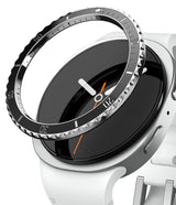 Galaxy Watch 8 40mm | Bezel Styling Premium - A black, notched metal bezel ring hovering above a white smartwatch face.