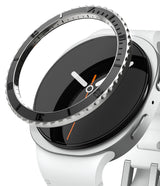 Galaxy Watch 8 40mm | Bezel Styling Premium - A black, notched metal bezel ring hovering above a white smartwatch face.
