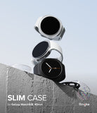 Galaxy Watch 8 40mm Case | Slim - Three slim protective cases for Galaxy Watch 9/8, 40mm are shown floating above a concrete ledge against a pale blue sky. The cases are transparent with white and black silicone bands, with one case fitted on a black watch.