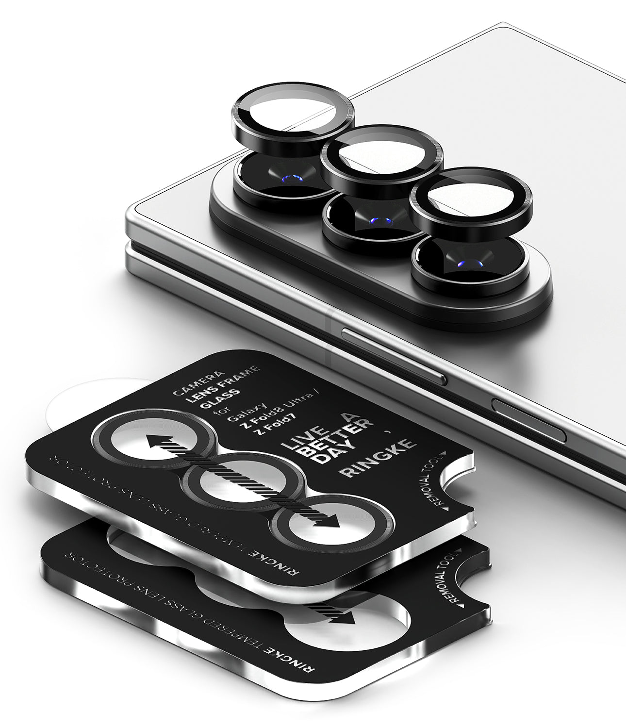 Galaxy Z Fold 8 Ultra | Camera Lens Frame Glass (2 Pack) - Three black camera lens protectors with silver edges are shown, with one set mounted on the camera module of a silver smartphone and a second set displayed flat in front with printed installation arrows and text.