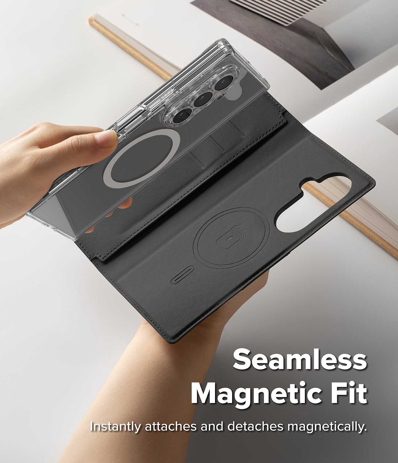 Galaxy Z Fold 8 Ultra MagSafe Wallet | Folio Grip Wallet Magnetic - A phone folio case shown being held by two hands, with one hand lifting a transparent magnetic cover layer over a dark gray folio base. The case includes a camera cutout, card slot, and circular magnetic ring.