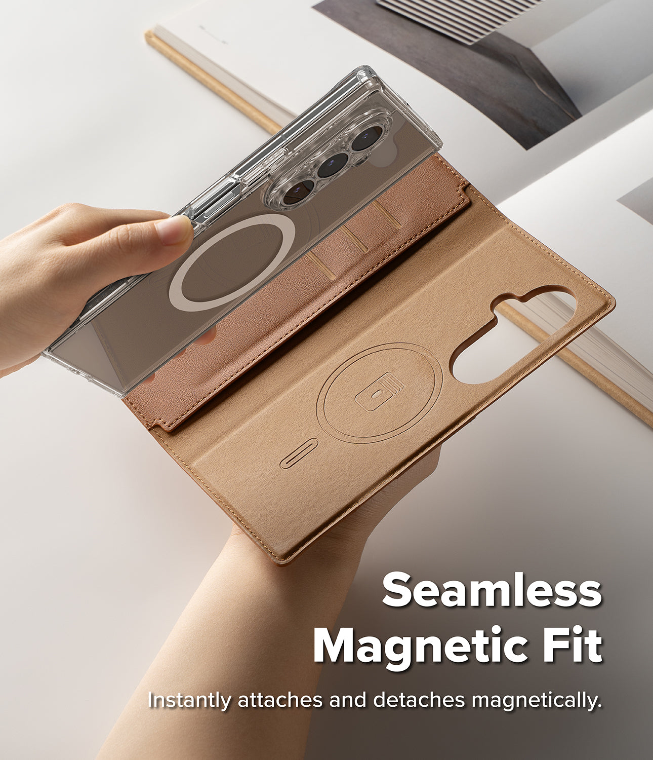 Galaxy Z Fold 8 Ultra MagSafe Wallet | Folio Grip Wallet Magnetic - A tan magnetic folio phone case is shown open and being held by two hands, with a smartphone partially inserted. The case has a clear outer back panel with a circular magnetic ring, card slots, and a cutout for the camera.