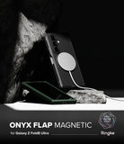 Galaxy Z Fold 8 Ultra Case | Onyx Flap Magnetic - A black smartphone case with a circular magnetic flap is shown leaning against a dark rock on a white surface, with a phone inside and a charging cable attached. Text at the bottom reads 'ONYX FLAP MAGNETIC for Galaxy Z Fold8 Ultra' with Ringke branding.