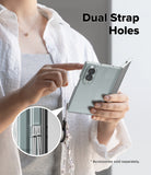 Galaxy Z Fold 8 | Fusion - A person holds a light blue folding smartphone in a clear case with a dangling cord and charm. The image includes the text 'Dual Strap Holes' and a circular inset showing the cord threaded through the phone's camera cutout.