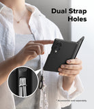 [Bundle] Galaxy Z Fold 8 | Onyx Flap (BK) + Screen Protectors (2P) - A person holds a black foldable phone case with a dangling strap and ring, demonstrating dual strap holes. A circular inset shows the strap attachment detail.