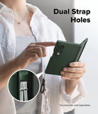 Galaxy Z Fold 8 Case | Onyx Flap - A person holds a dark green phone case with a wrist strap and tassel, pointing to the case while text reads 'Dual Strap Holes.' A circular inset shows the strap attachment detail.