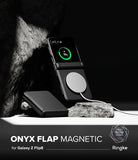 Galaxy Z Flip 8 Case | Onyx Flap Magnetic - A black magnetic flip phone case shown on a Samsung Galaxy Z Flip8, with the outer flap closed and the inner flap open, featuring a circular magnetic ring. The phone inside displays a green charging icon.