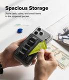 Wallet  | Tech Magnetic - A clear phone case with a black zippered pocket and ring holder, held in two hands to demonstrate storage space. The text 'Spacious Storage' is displayed at the top, with cash and a magazine in the background to illustrate use cases.