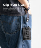Wallet  | Tech Magnetic - A close-up of a person wearing blue jeans and a dark gray shirt, showing a black zippered wallet or card holder clipped to the back pocket with a strap and ring. White text at the top reads 'Clip it On & Go! Includes a Carabiner Ring for easy, secure attachment.