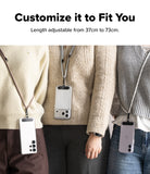 Holder Link Strap | Black - Three people wearing smartphones on adjustable crossbody straps over sweaters and casual clothing.