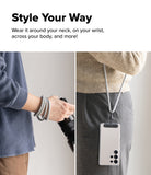 Holder Link Strap | Black - A grey rope strap worn as a wristband and as a crossbody phone lanyard.