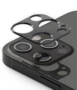 iPhone 12 Pro Max | Camera Styling - iPhone 12 Pro Max - A black camera lens protector hovering above the triple-lens array of a dark smartphone.