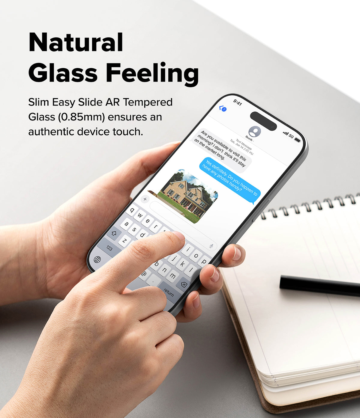 iPhone 18 Pro Max Screen Protector | Easy Slide AR Tempered Glass - A person holds a slim smartphone with a transparent glass back, showing a messaging screen, over a light gray surface with a notebook and pen nearby. Text on the image reads 'Natural Glass Feeling' and describes the easy slide AR tempered glass.
