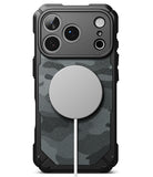 iPhone 18 Pro Max Case | Rugged Gear Magnetic - A rugged black phone case with a dark gray and black camouflage pattern back panel, featuring a large circular MagSafe-compatible magnetic ring on the back and a white charging cable extending from it, shown on a white background.