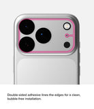 iPhone 18 Pro Camera Protector | Camera Full Cover Tempered Glass (2 Pack) - Close-up of the back of a silver smartphone showing a pink adhesive camera-edge protector or frame applied around the camera cutout, with text below describing double-sided adhesive lines for clean installation.