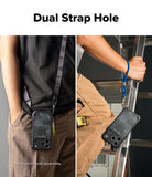 iPhone 18 Pro Case | Rugged Gear Magnetic - A phone case with a dark camouflage pattern is shown being worn and held by a person, demonstrating a dual strap design. The left panel shows the case hanging from a shoulder strap, and the right panel shows a hand holding a ladder while wearing a blue lanyard attached to the case.