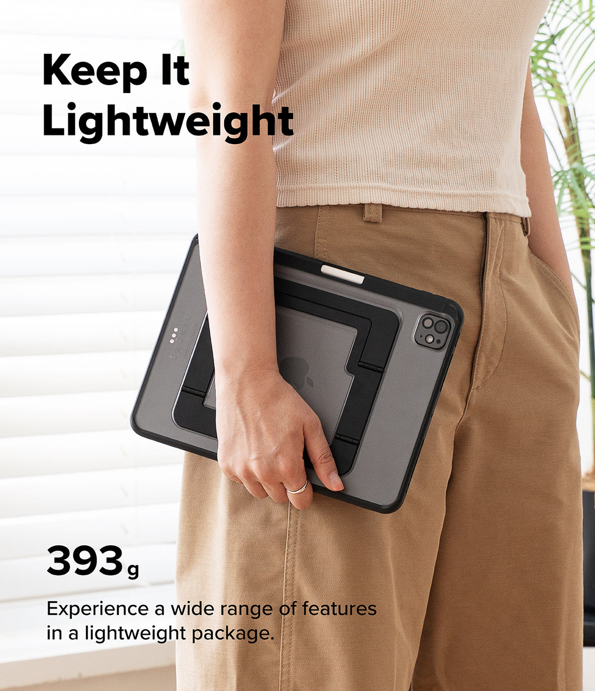Ringke Apple iPad Pro (11") / Air (11", 10.9") Case [Multiverse Case] - A person in a beige ribbed top and tan pants holds a slim black tablet case with a built-in screen protector and stand. Large text reads 'Keep It Lightweight' and '393 g' with additional feature copy, against a bright indoor background with window blinds and a plant.