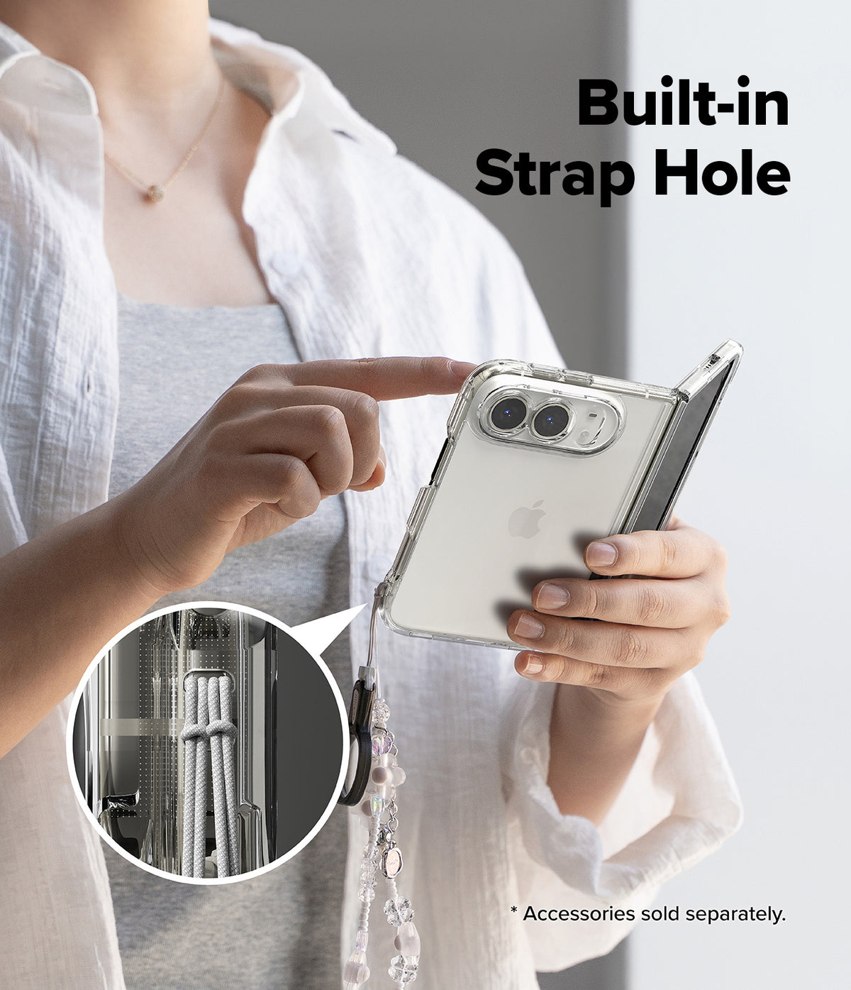 iPhone Duo | Fusion + Hinge (2P) all-groups - A person holds a clear foldable phone case with a built-in strap hole and dangling charm, shown against a light gray background with the text 'Built-in Strap Hole' and a circular inset detail of the strap hardware.