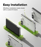 iPhone Duo | Hinge Dual Easy Film (2P) - Three smartphones shown from different angles resting on translucent bright green custom-fit phone stands, with marketing text at the top reading 'Easy Installation' and 'Effortless installation made simple with a custom-fit stand.'.