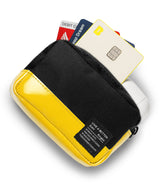 Mini Pouch Tarpaulin | Brick - Yellow and black zippered pouch holding credit cards and white wireless earbuds.