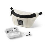 Mini Pouch | Sling Bag - Cream-colored mini pouch with black zipper and label next to white wireless earbuds and charging case.