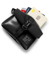Mini Pouch Tarpaulin | Roll Top - Black roll-top pouch with a buckle strap and credit cards tucked inside on a white background.