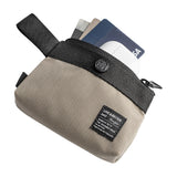 Mini Pouch | 2-Way Bag Miniature - Beige and black fabric pouch containing credit cards and a white wireless earbud case.