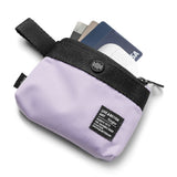Mini Pouch | 2-Way Bag Miniature - A light purple mini pouch with a black strap, button closure, and cards tucked inside.