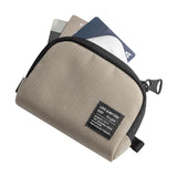Mini Pouch | Half-Pocket - Beige textured mini pouch with black trim and a branded label, holding three credit cards.