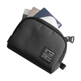 Mini Pouch | Half-Pocket - Black textured mini pouch with a zipper and a branded label, holding three credit cards inside.