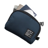 Mini Pouch | Half-Pocket - Navy blue zippered pouch with a branded fabric tag containing three credit cards.