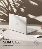 MacBook Neo | Slim - A white slim protective case for a MacBook Neo is shown on a desk with a silver MacBook inside, alongside a white mouse, keys, and notebooks. The image features text overlays reading 'Ringke SLIM CASE for MacBook Neo' and a 'MacBook Unboxing Experience' badge, set against a warm beige wall with leaf shadows.