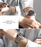 Galaxy Watch 9 / 8 | Metal One Air - A three-panel collage showing a silver stainless steel smartwatch with a metal link band worn on a person's wrist. The panels include close-ups of the watch and a text overlay that reads, 'Transform your Galaxy Watch into a classic, luxury style.