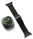 Galaxy Watch Ultra 2 / 1 | Metal One Mesh - A black smartwatch with a dark green watch face is shown next to a black mesh metal watch band on a clean white background.