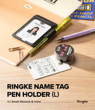 Pen Holder | Name Tag (2P) - A Ringke name tag pen holder in black faux leather, shown holding a sample ID badge. The holder is styled on a wooden desk with a green pen, a purple mechanical pencil, a gold paperclip, and a roll of washi tape.