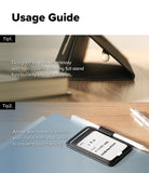 Pen Holder | Name Tag (2P) - A usage guide infographic showing two tips for using a black leather stylus case with a smartphone. The top panel shows the case partially open on a wooden desk, and the bottom panel shows the case open on a blue notebook with a stylus attached to its card slot.
